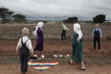 Kids playing with kite on a Sunday family meeting