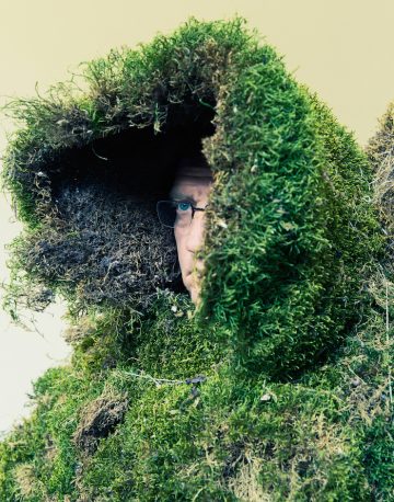 Man under a hood of moss.  The Moss Men of Bejar.