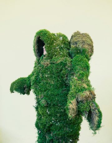 Woman dressed in a suit of moss.  The Moss Men of Bejar.