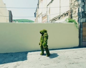 A man walking through Bejar dressed in moss.  The Moss Men of Bejar.