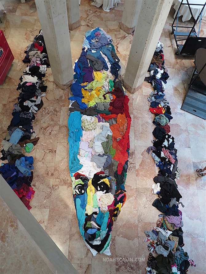 A Giant Anamorphic Portrait Created From Arranged Clothing