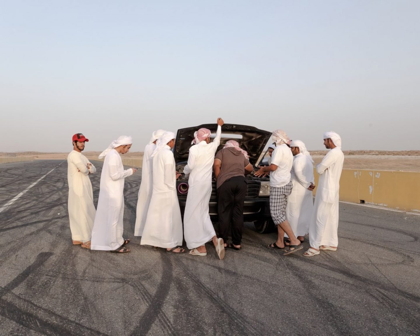 Young men address a mechanical problem.