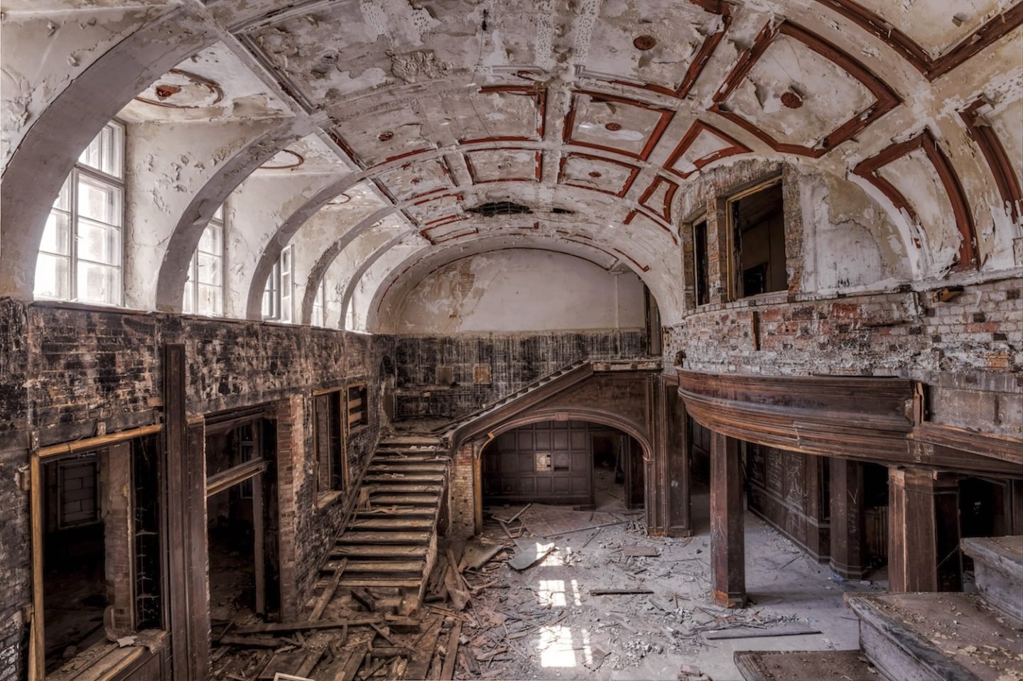 abandoned wooden entry hall with staircase
