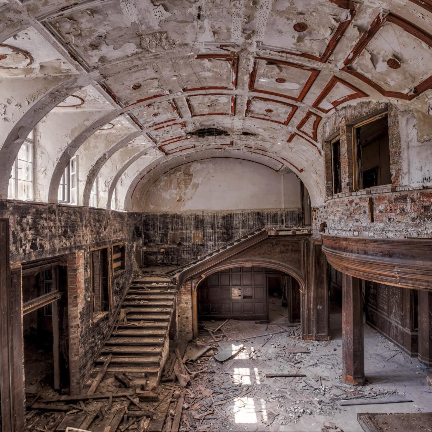 abandoned wooden entry hall with staircase