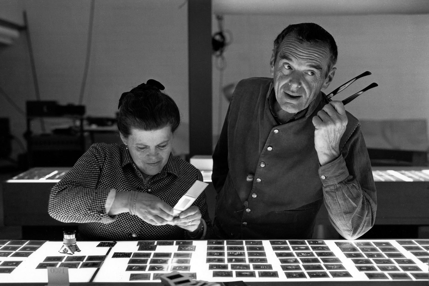 An Eames Celebration. Charles and Ray Eames selecting slides. ∏ Eames Office LLC