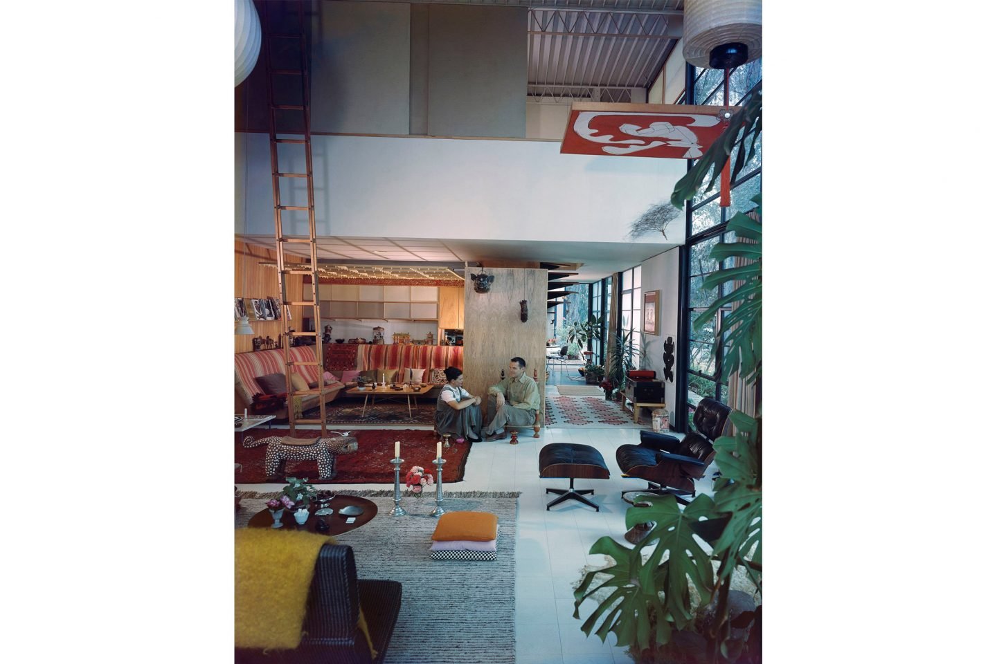 An Eames Celebration. Charles and Ray in the living room of the Eames House, 1958