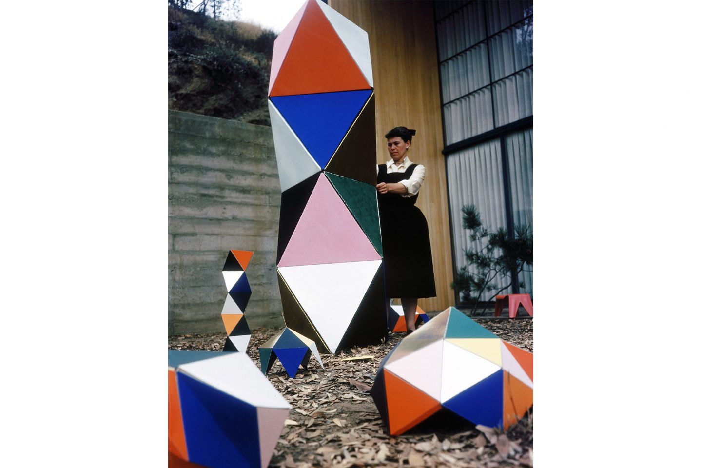 Ray Eames with an early prototype of The Toy in the patio of the Eames House, 1950. ∏ Eames Office LLC