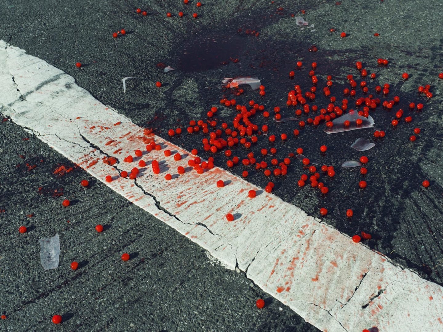 USA. New York City, NY. 2014. Cherries spilled on crosswalk.