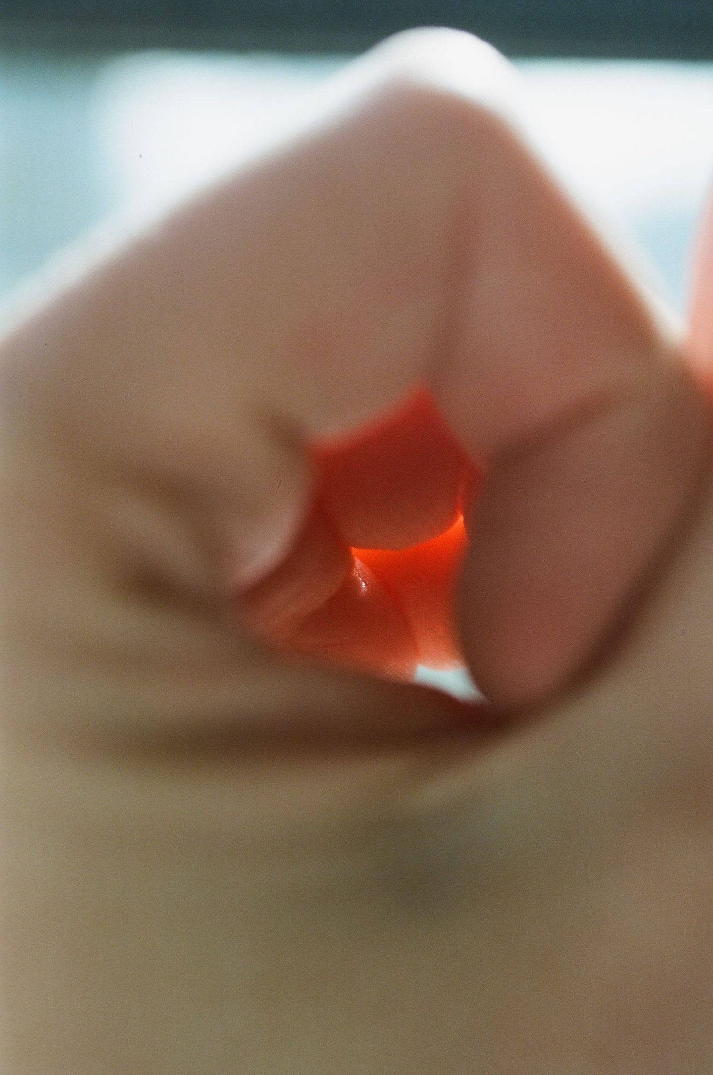 a blurred photograph of blood orange wedges on a dark background from Lina Scheynius photo - essay for Tabayer jewelry