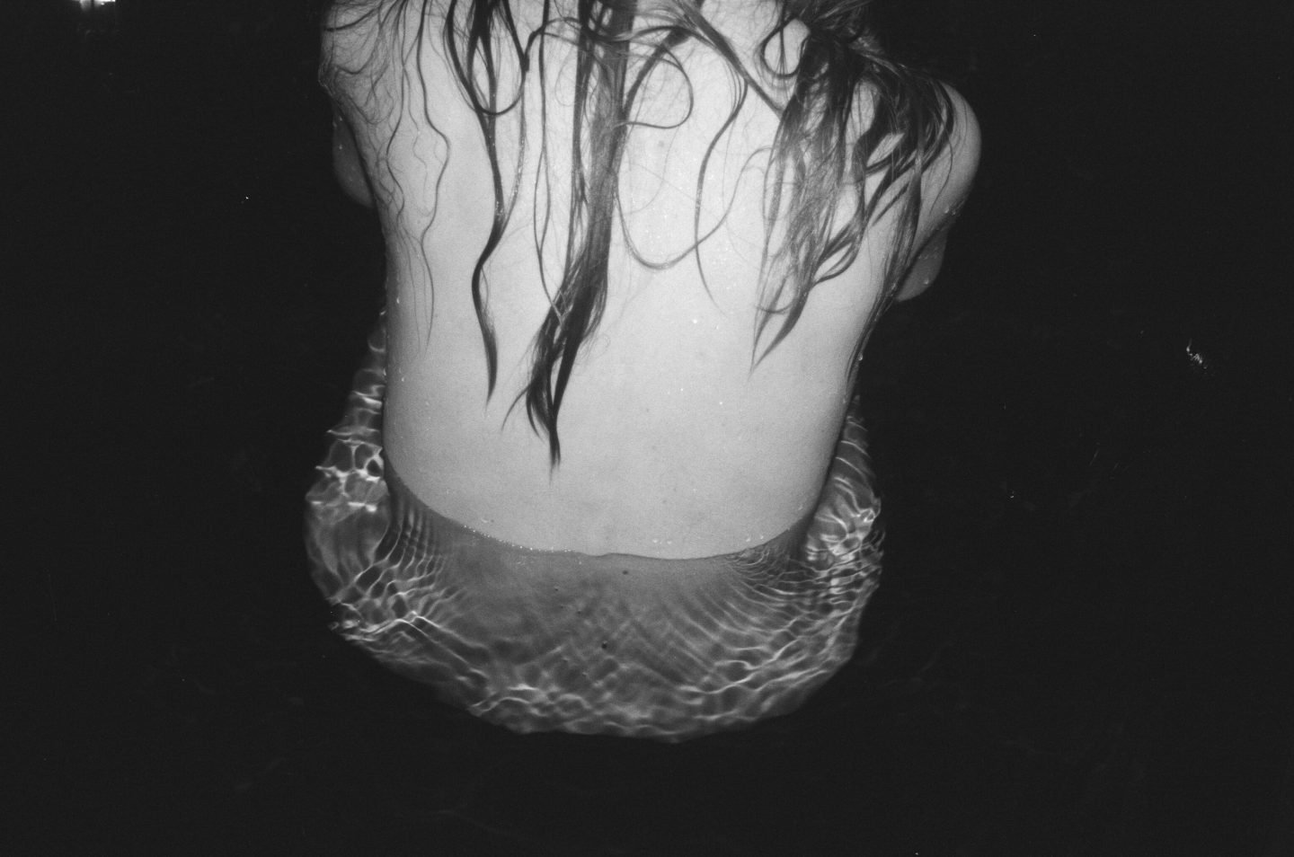alt=“a black and white photo of a woman back with wet hair from Lina Scheynius photo - essay for Tabayer jewelry"