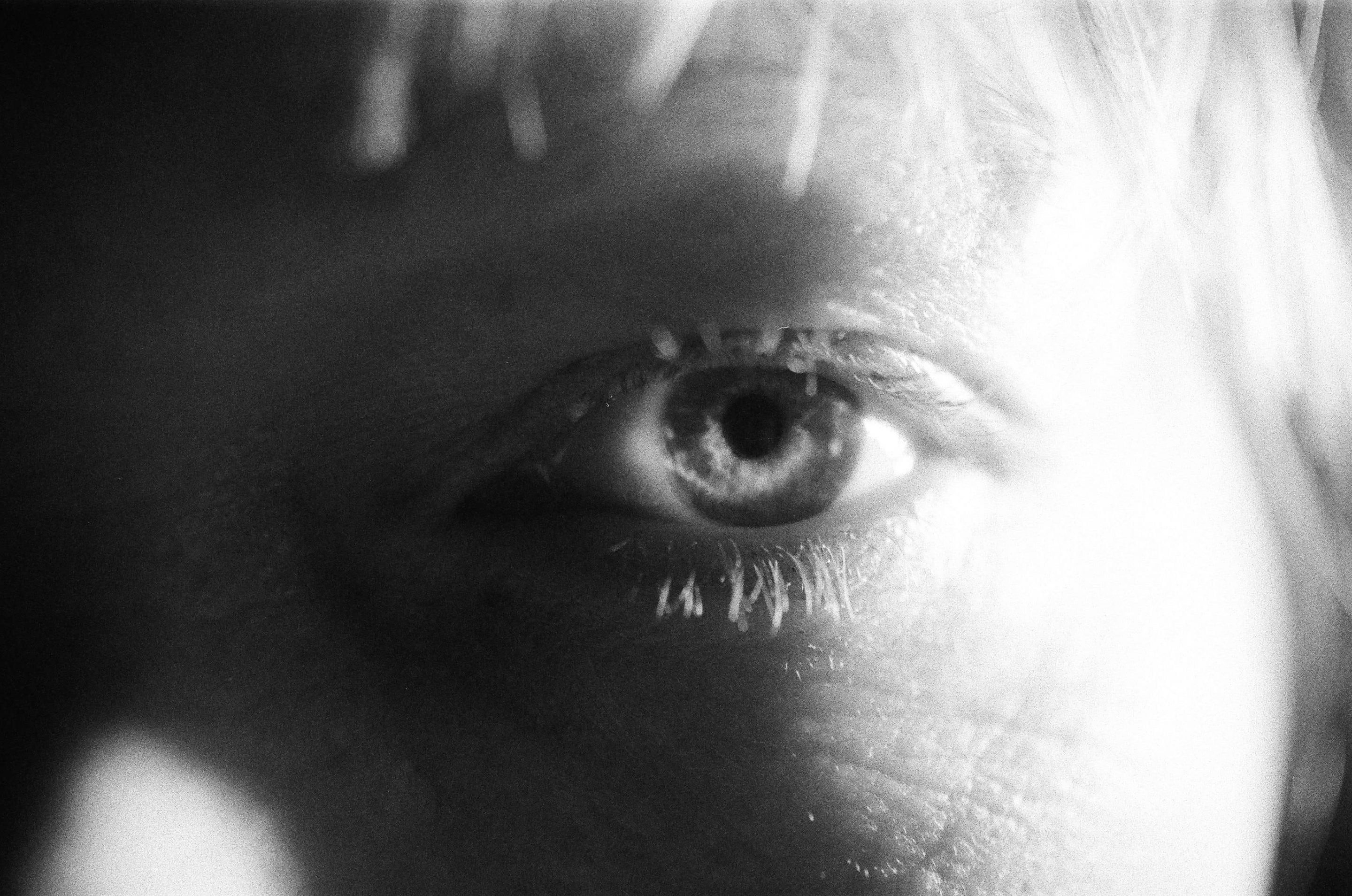 alt=”a black and white photo of a woman’s eye from Lina Scheynius photo - essay for Tabayer Jewelry"